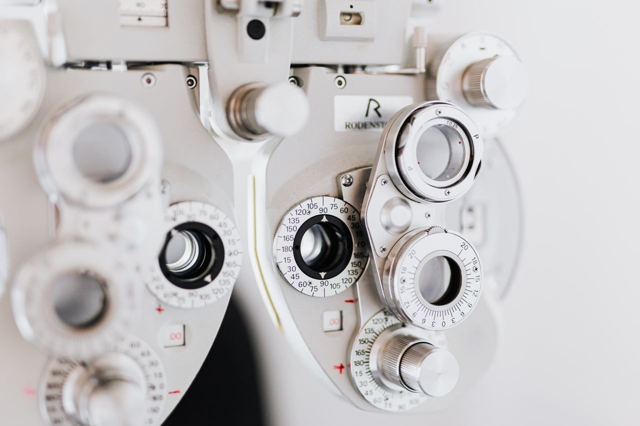 Detailed view of an optical phoropter used in eye exams, showcasing precision and medical technology.